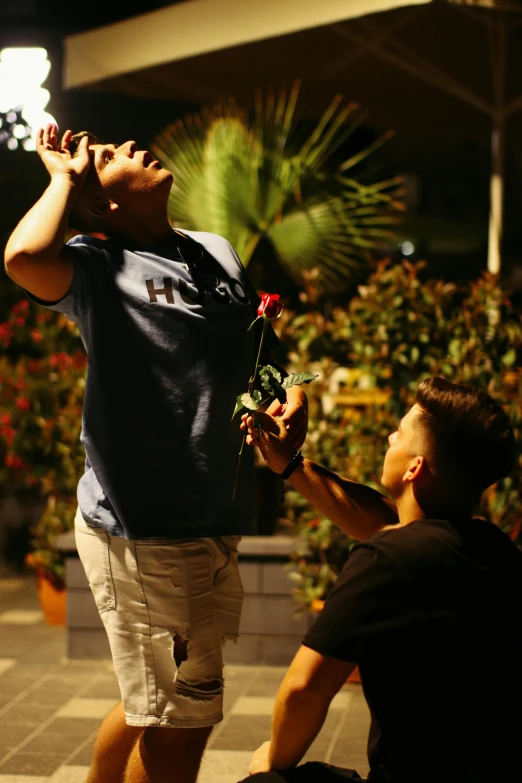 a man kneeling down next to another person