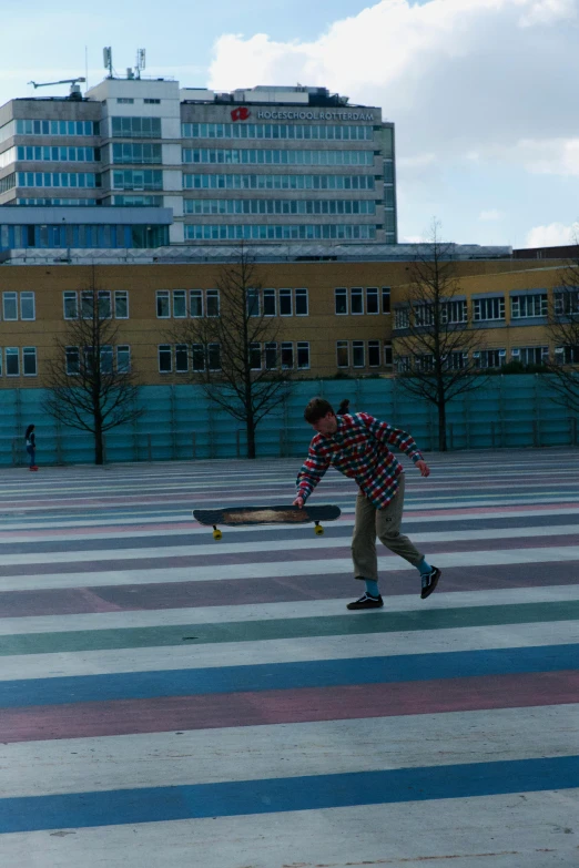 a skateboarder skates in a large painted square