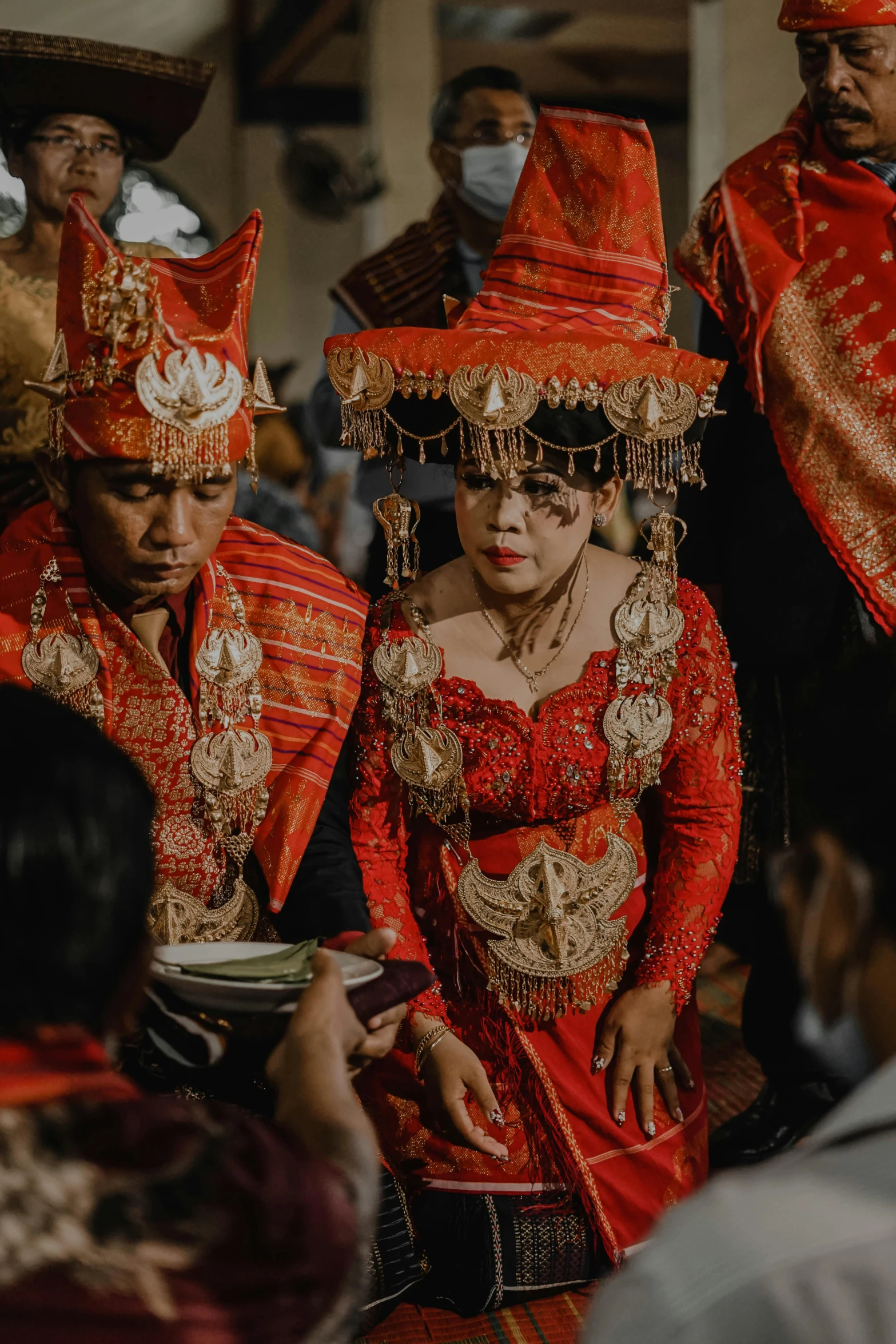 a woman dressed up in bright red at a wedding