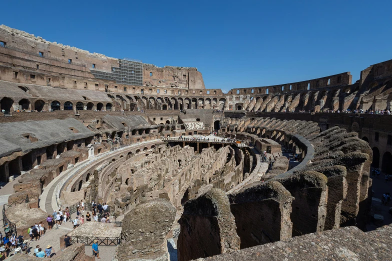 people gather in an ancient building at an arena