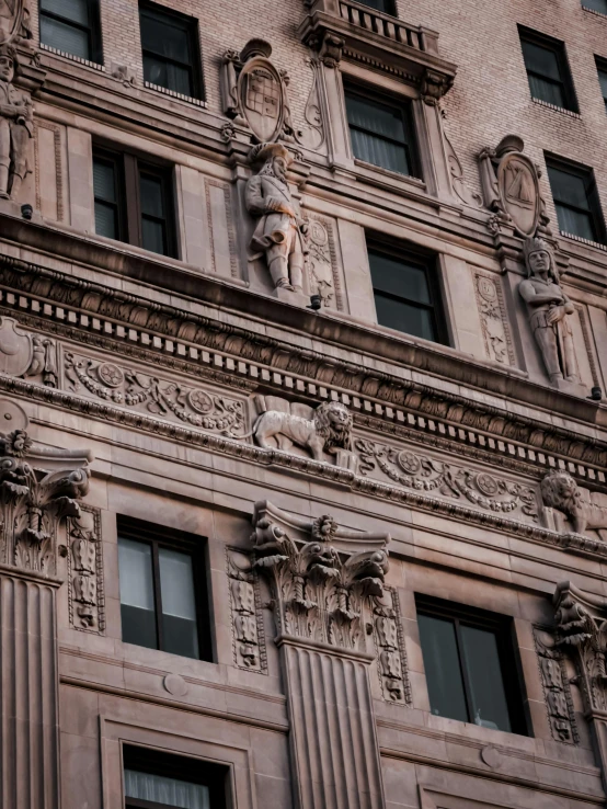 a very tall building with many statues on the side