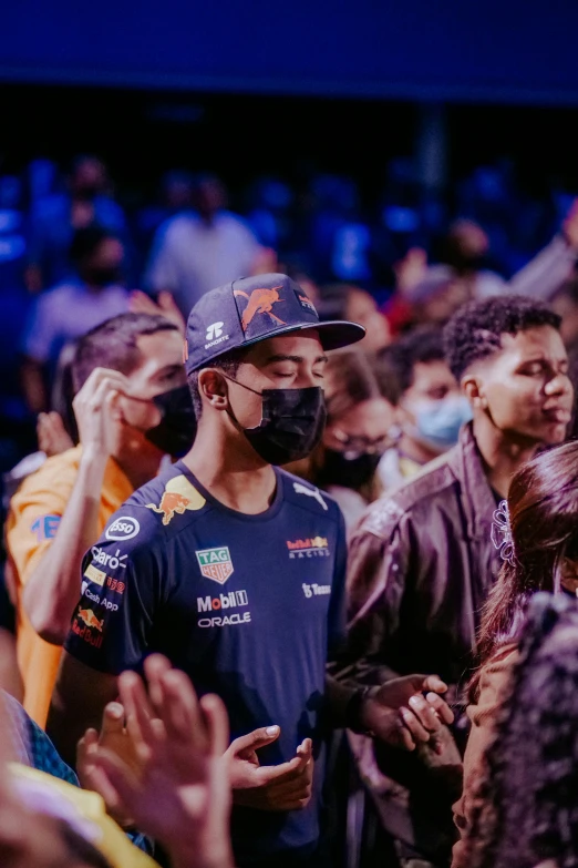 a man in a crowd wearing a face mask