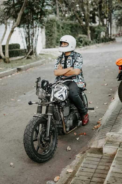 a man sitting on the back of a motorcycle