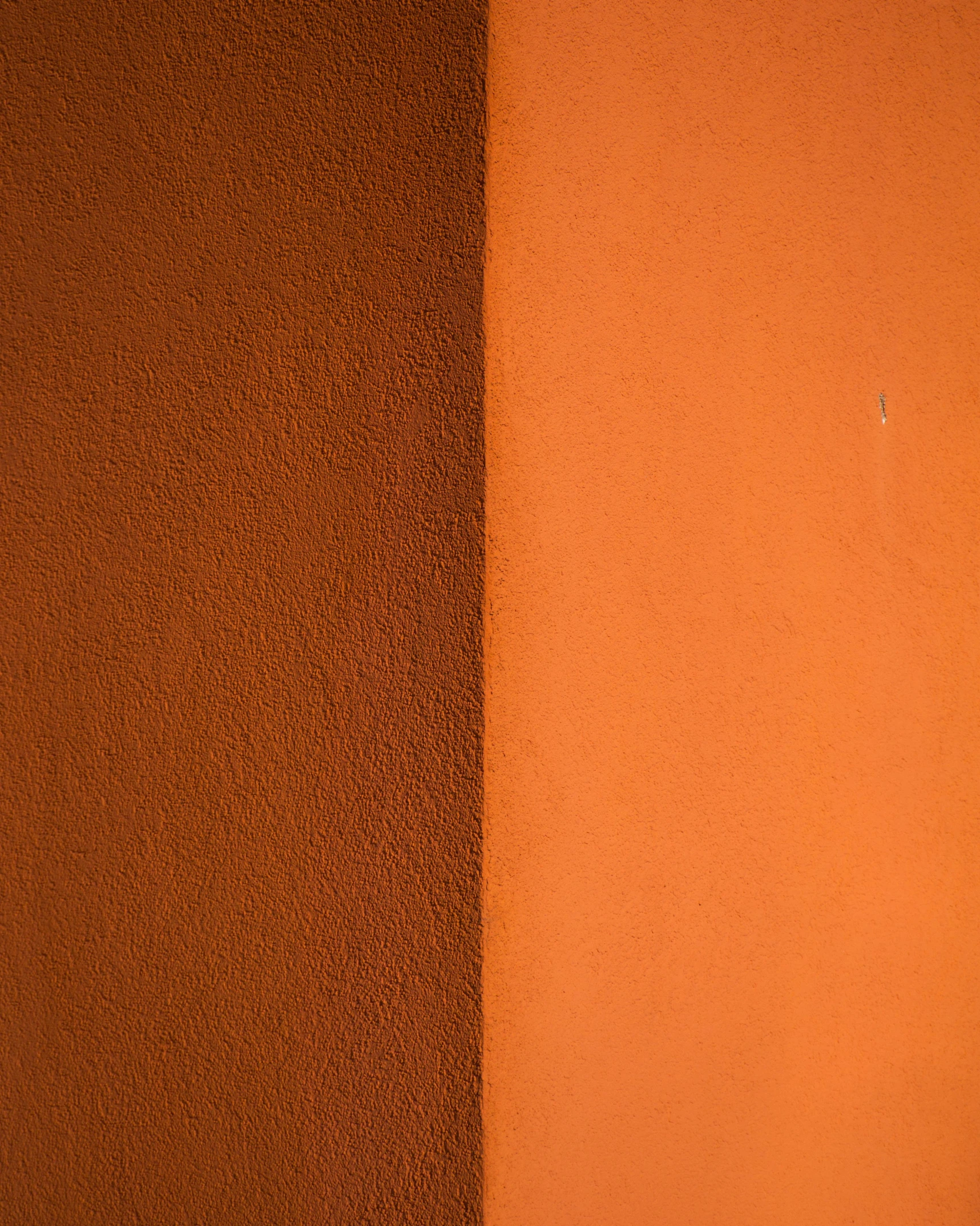 a piece of material against an orange wall