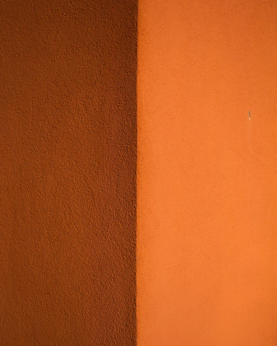 a piece of material against an orange wall