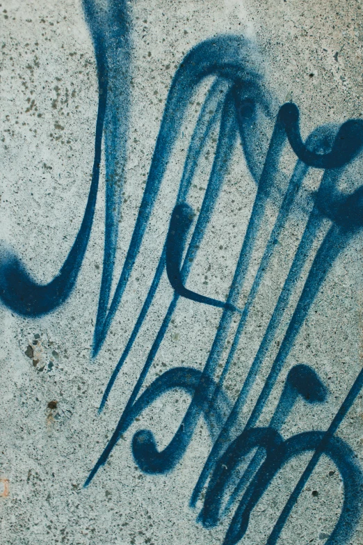 graffiti written on cement and letters, including a line