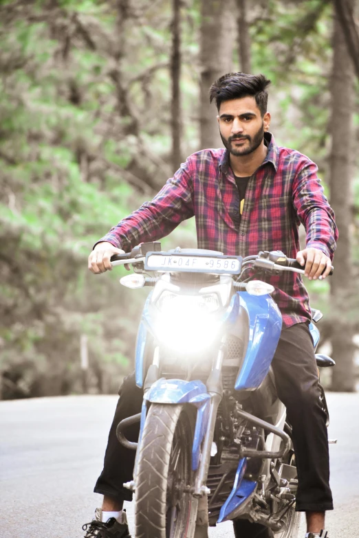 a man is on a motorcycle in the road