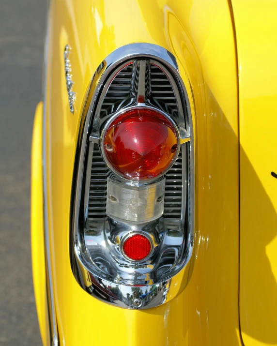 the rear view of an old yellow classic car