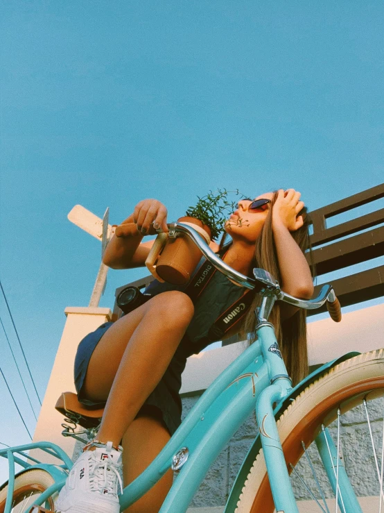 a girl sitting on a bench on top of a bicycle