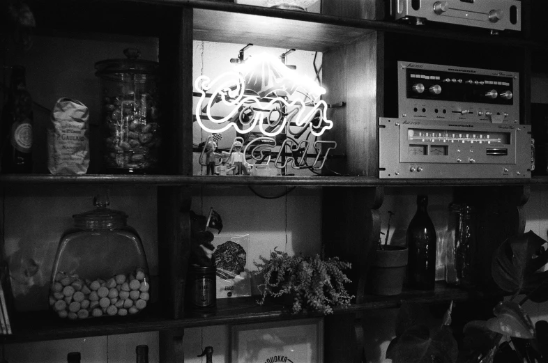 some shelves filled with electronics and a juke box