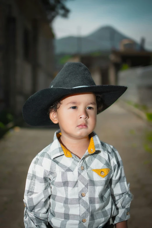 a  with his cowboy hat looking off into the distance