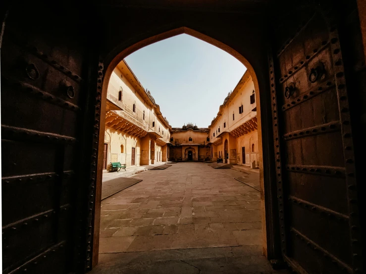 an arch leading into an area with several buildings