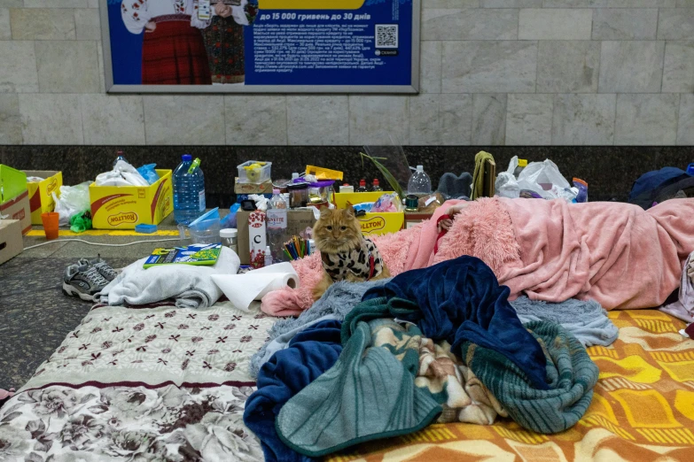 piles and piles of dirty clothing on a bed