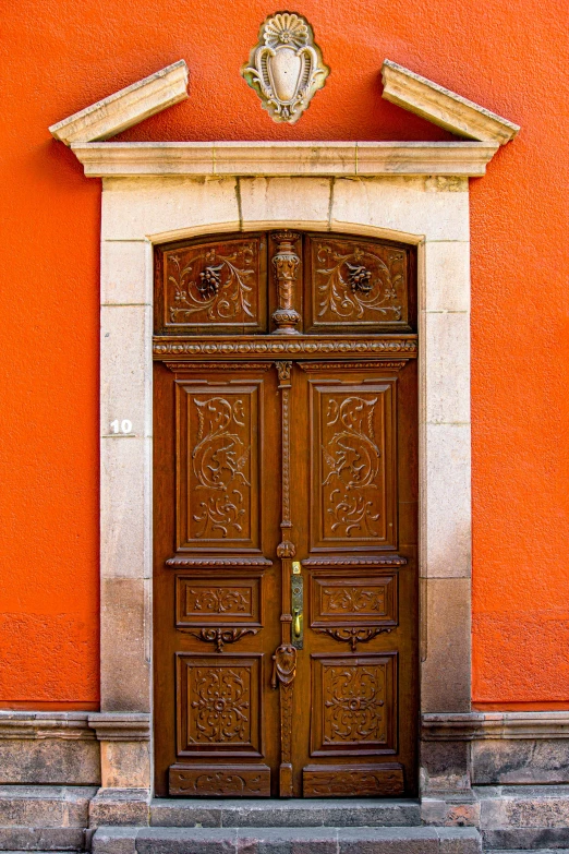 an orange building with a big wood door