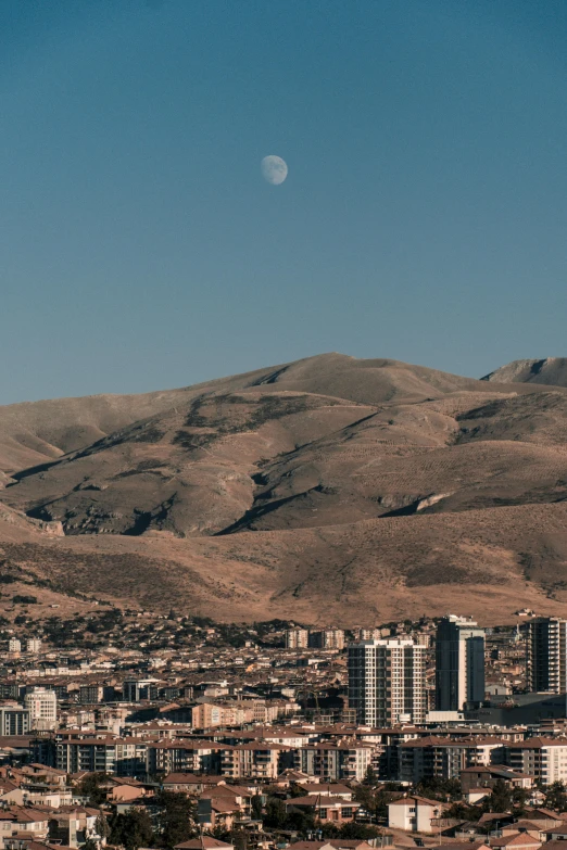 an aerial view of a large city with a full moon