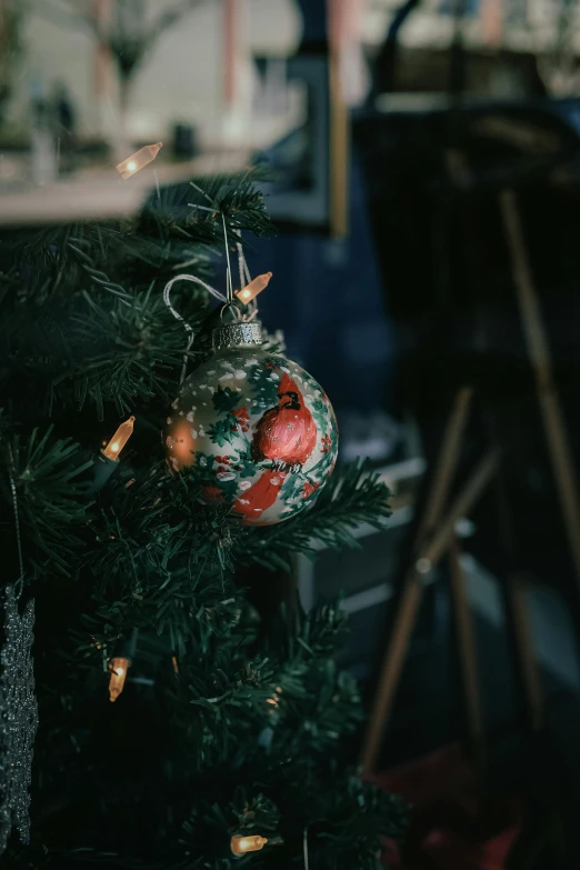 a christmas tree with ornaments hanging off the nches