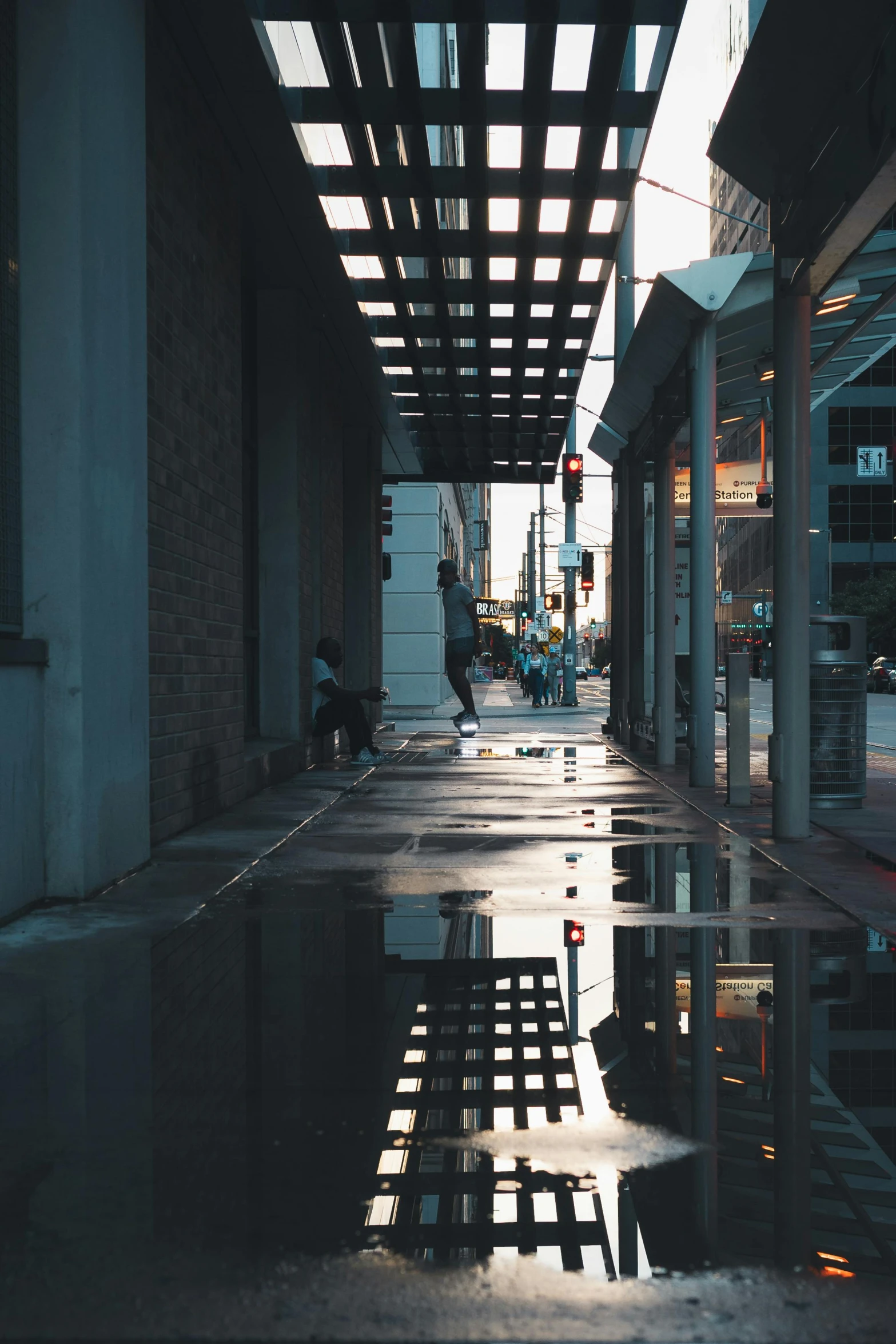 a person is walking in a wet sidewalk