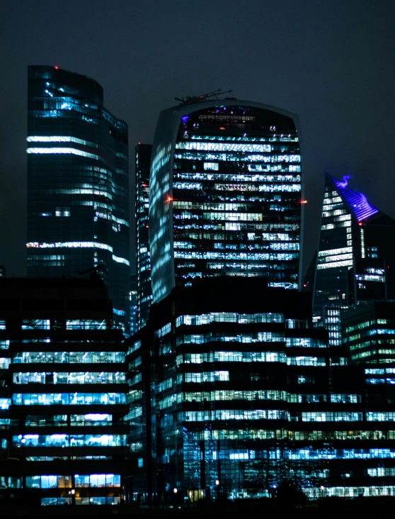 tall buildings lit up in the night time