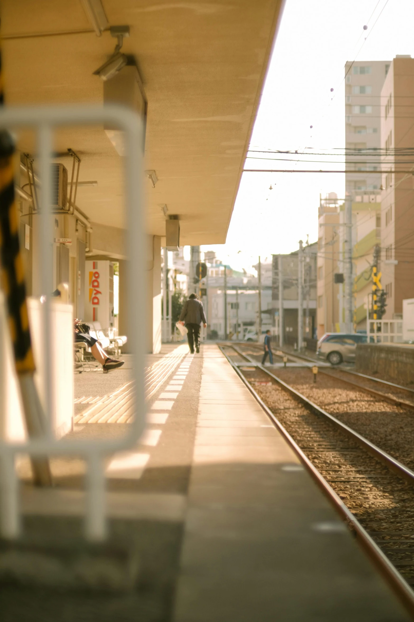 person walking by train tracks in urban city