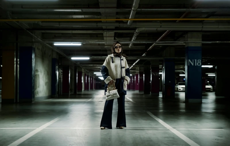 a woman with a cane in a parking garage