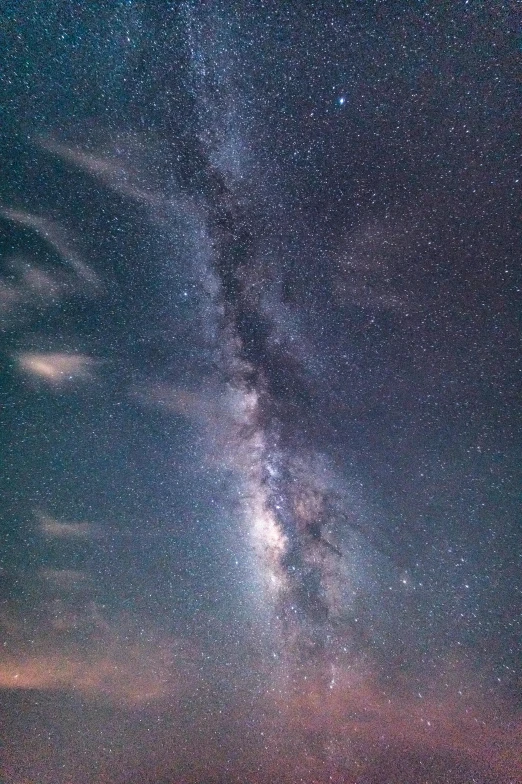 a boat floating in the ocean under a night sky