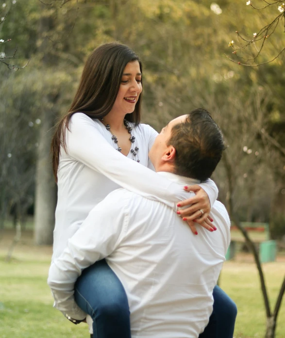 an image of a man giving his wife piggyback