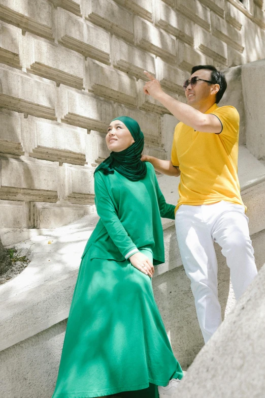 a man and a woman standing on steps