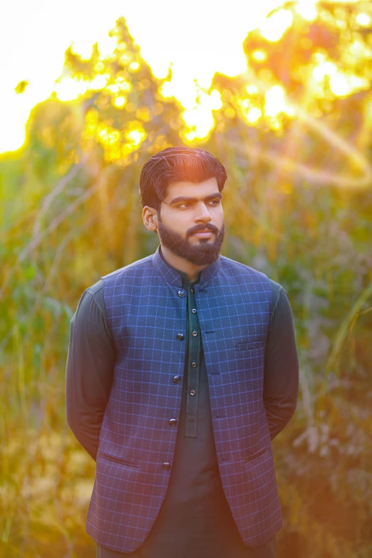 a man in a suit standing in the grass