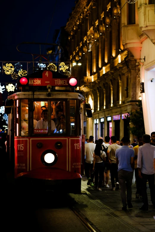 a cable car driving through a night time area