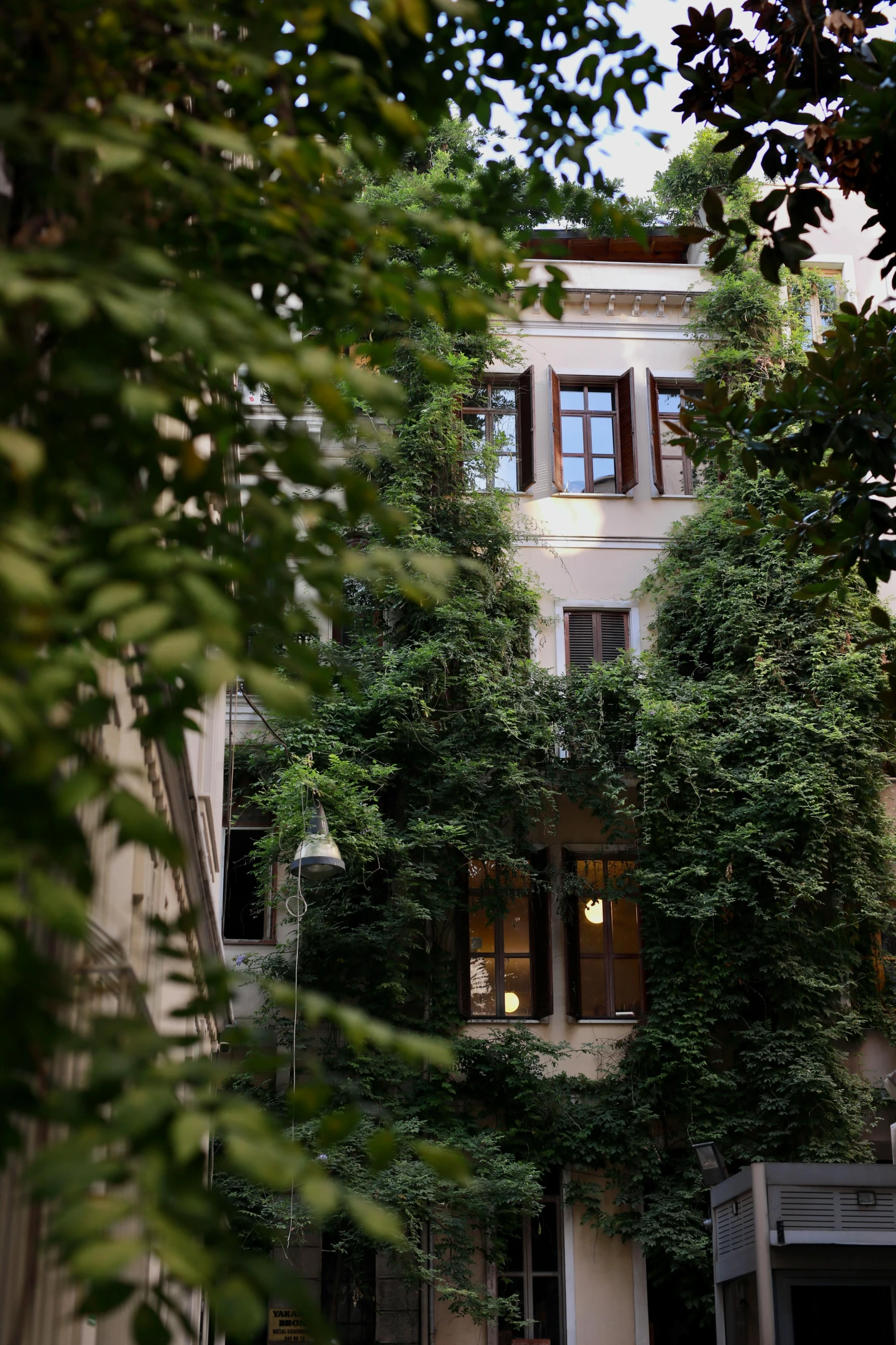 a building covered in trees during the day