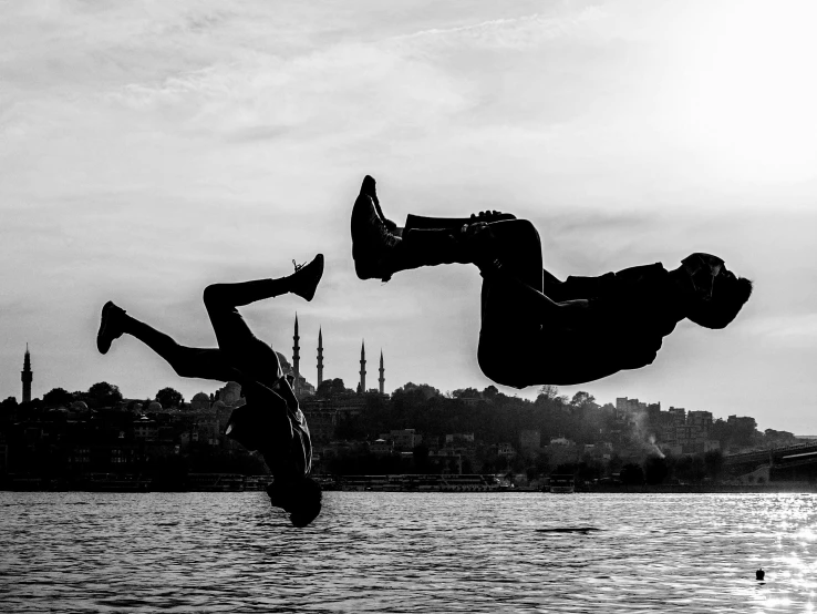 the two people are doing a trick in the air