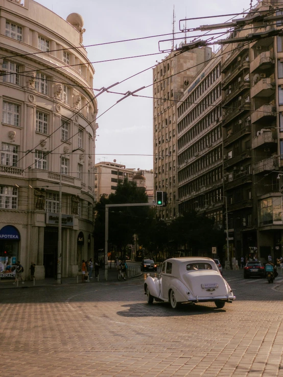 a street scene with a white car and many buildings