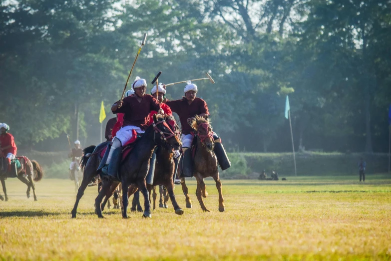 group of people on horses in a polo match