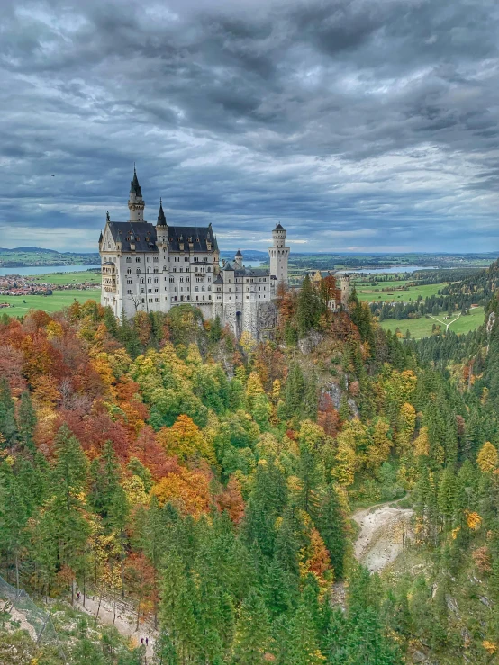 a castle with many trees and green field