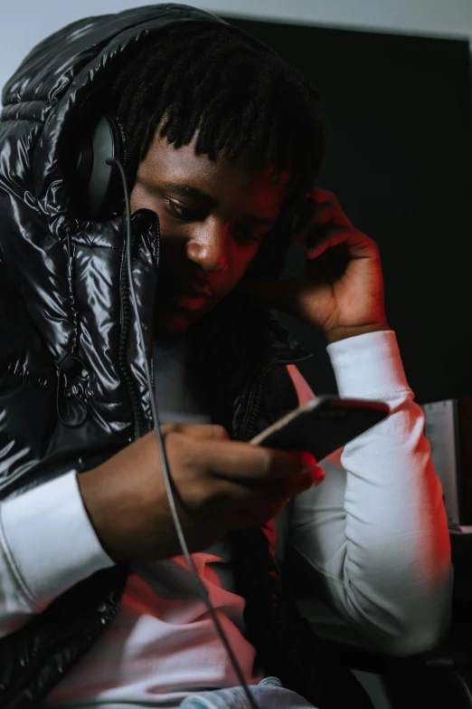 a man with dread locks on holding a cell phone to his ear