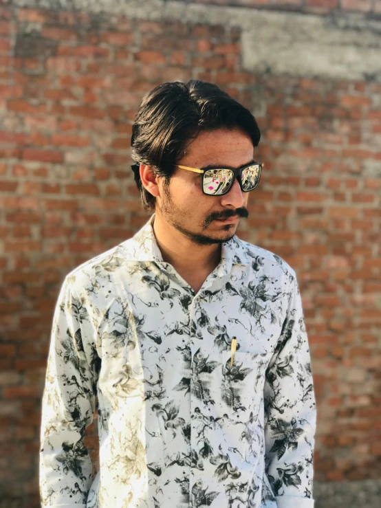 a young man with sunglasses looking away