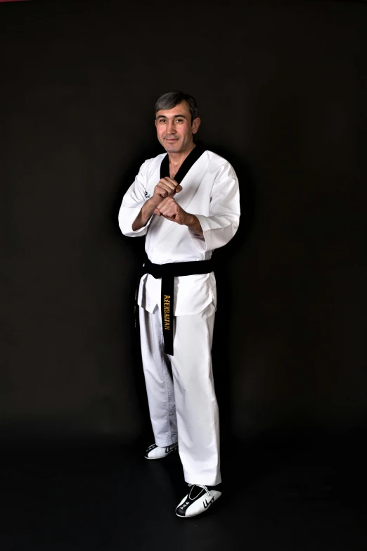 a man standing with a white karate outfit on