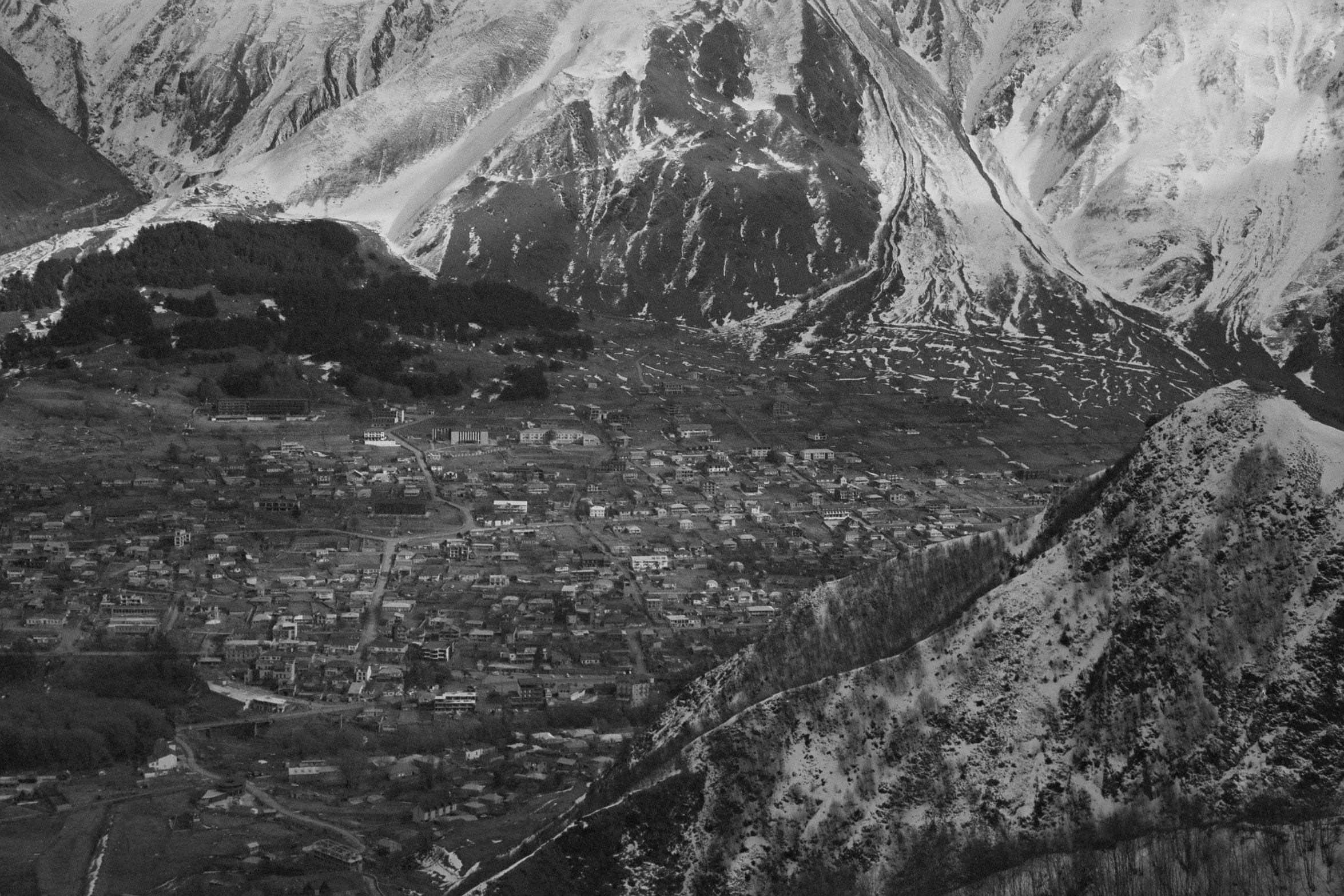 an aerial po of some buildings and mountains