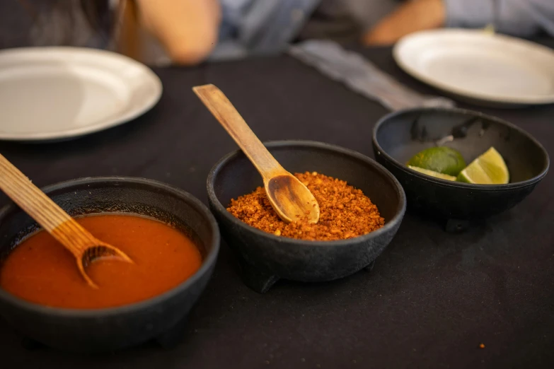 a table topped with bowls of food next to silverware