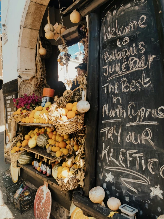 a sign displaying a food stand next to some fruit