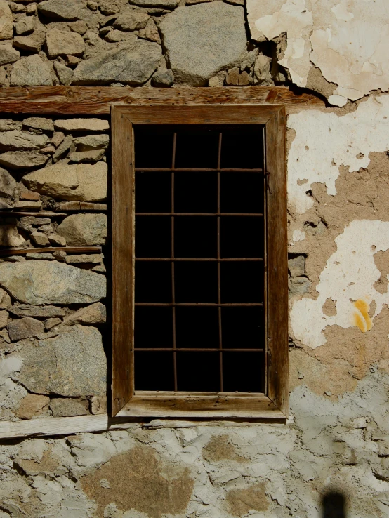 a window with bars attached to the brick wall