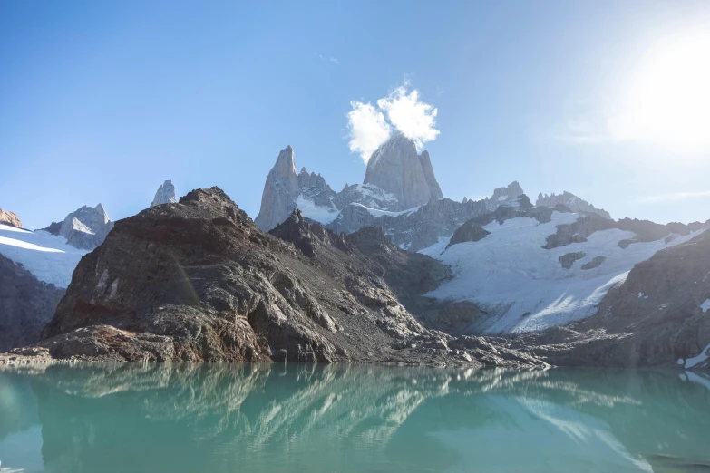 a beautiful day for skiing on a snowy mountain lake