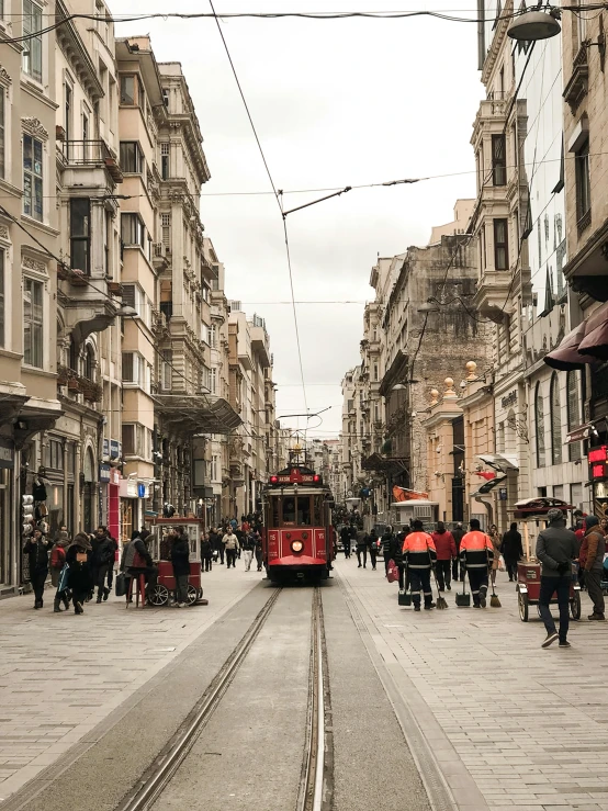 a city street with some people and a tram