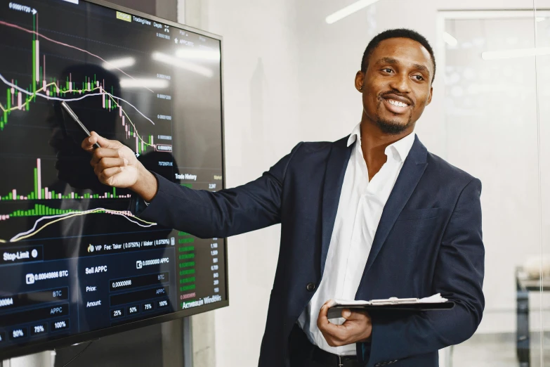 a man holding up a paper next to a large poster