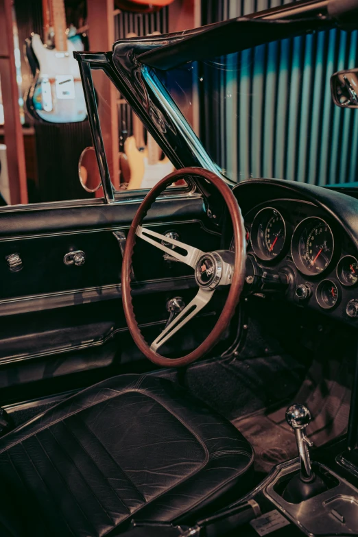 a black and brown car dashboard with wooden steering wheel