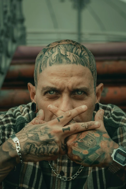 a man with lots of tattoos on his arms and hands