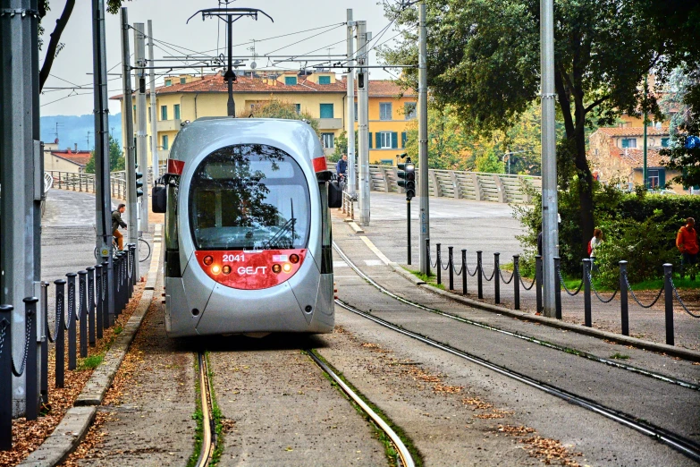 the tram is parked in a street stop in an area