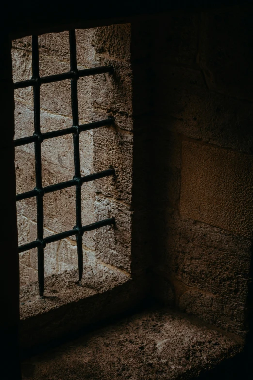 a barred window in an old  cell