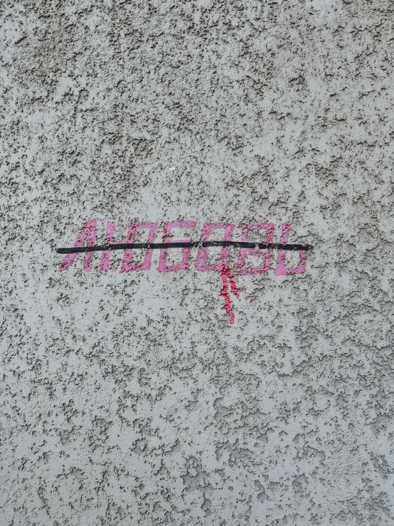 the word vandalism is written on the street and in pink