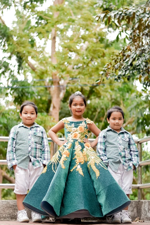 children are standing on a cement ramp and smiling